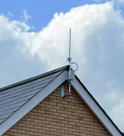 Compact aerial mounted at a house gable apex