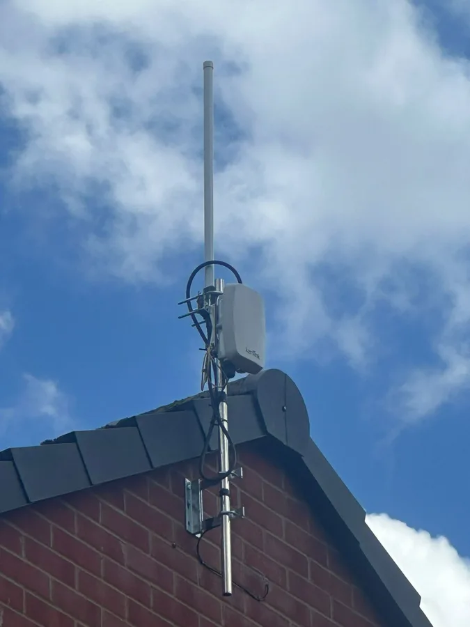 LoRaWAN smart-meter gateway and aerial mounted at a house gable